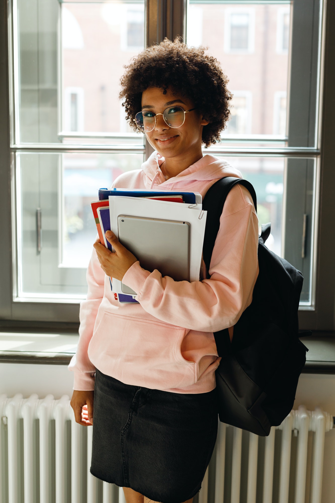 Young Smiling Student Standing At A Window Preparing For Lecture